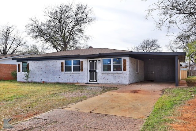 ranch-style home featuring a carport and a front yard