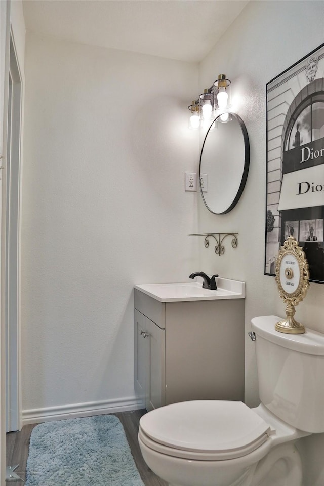 bathroom featuring vanity, toilet, and wood-type flooring