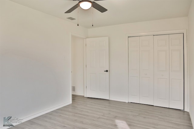 unfurnished bedroom featuring ceiling fan, a closet, and light hardwood / wood-style floors