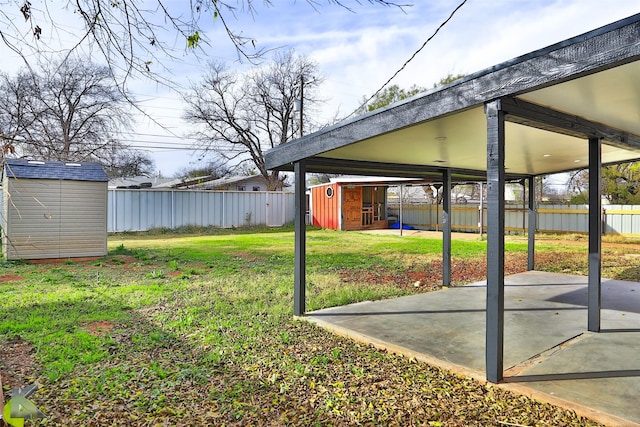 view of yard with a patio area and a storage shed