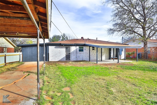 rear view of property with a lawn and a patio area