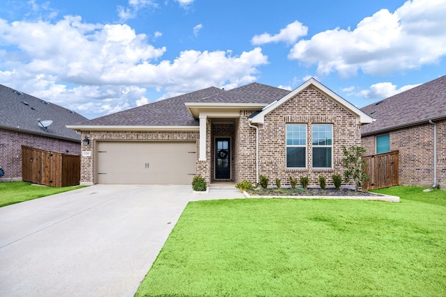 view of front of property featuring a front yard and a garage