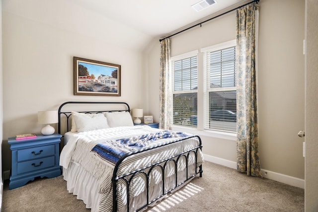 bedroom featuring light colored carpet and vaulted ceiling