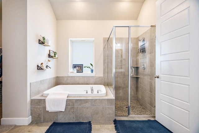 bathroom featuring tile patterned flooring and plus walk in shower