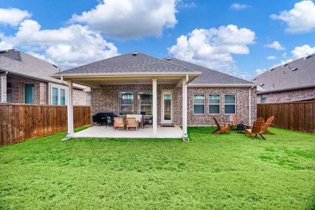 back of house featuring a yard and a patio area