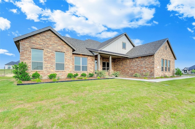 412 Collum, Azle, TX 76020 - view of front of home with brick siding, board and batten siding, a front lawn, and a shingled roof