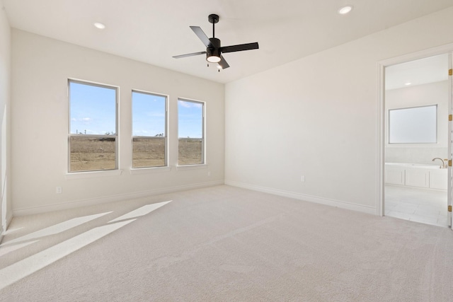 unfurnished room featuring light colored carpet and ceiling fan