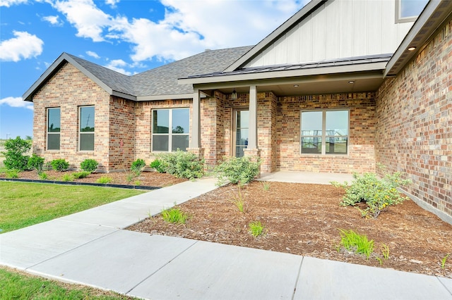 412 Collum, Azle, TX 76020 - view of front of house featuring brick siding, board and batten siding, roof with shingles, and a patio