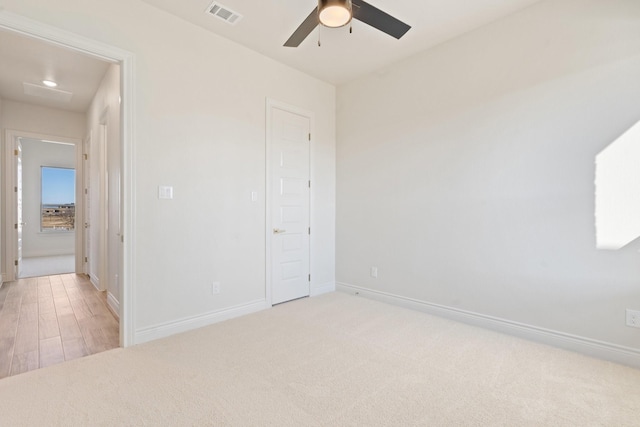 unfurnished bedroom featuring ceiling fan and light carpet