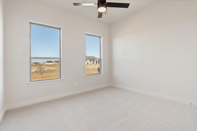 unfurnished room with ceiling fan and carpet flooring