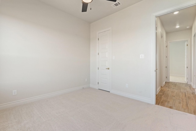 unfurnished bedroom with light colored carpet and ceiling fan