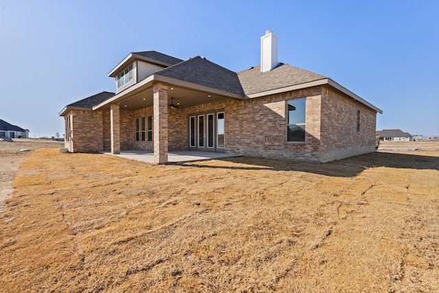 rear view of property featuring a patio area