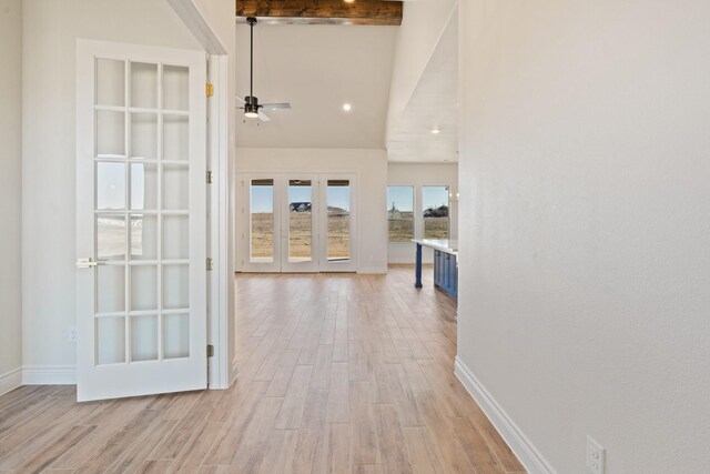 hall featuring light hardwood / wood-style floors, beamed ceiling, and french doors