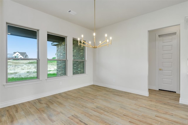 412 Collum, Azle, TX 76020 - empty room with a chandelier, light wood-style floors, and baseboards