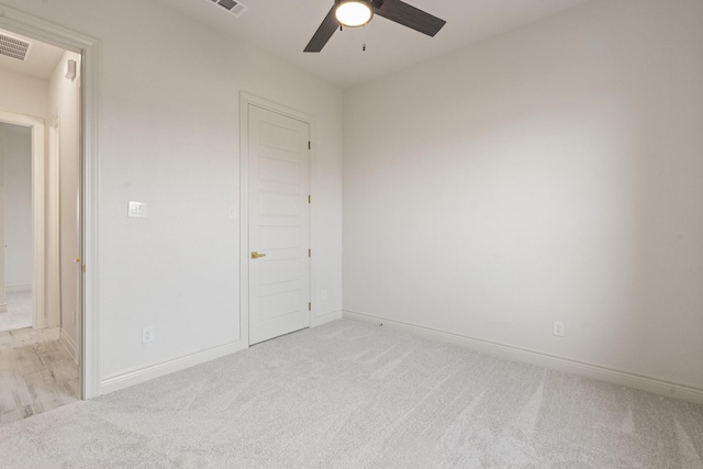 unfurnished bedroom with ceiling fan and light carpet