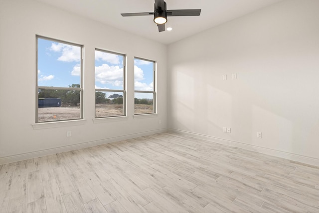 empty room featuring light hardwood / wood-style flooring and ceiling fan