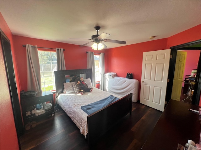 bedroom with ceiling fan and dark wood-type flooring