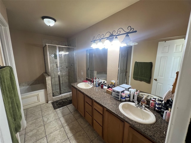 bathroom featuring plus walk in shower, vanity, and tile patterned floors