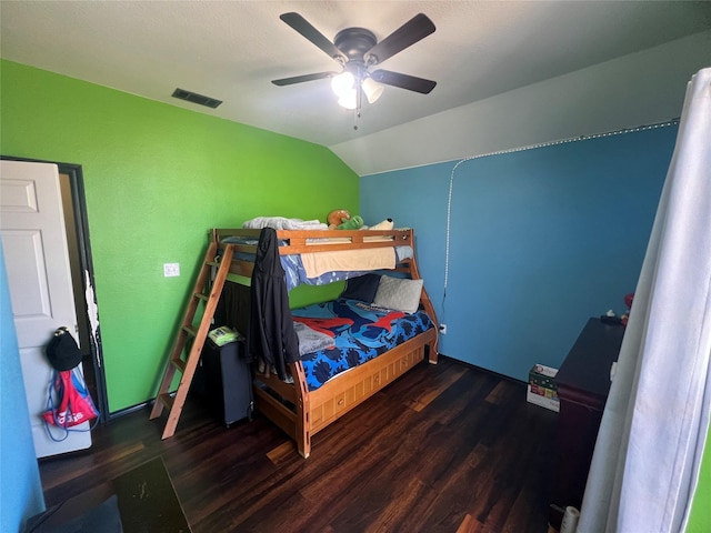 bedroom featuring ceiling fan, dark hardwood / wood-style flooring, and vaulted ceiling