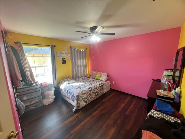 bedroom with ceiling fan and dark wood-type flooring