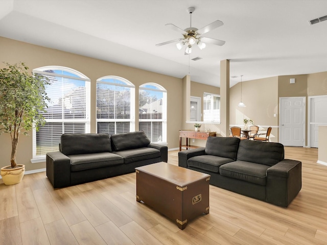 living room with ceiling fan and light wood-type flooring