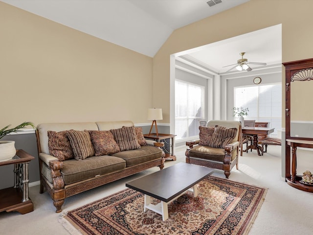 living room with ceiling fan, carpet floors, and vaulted ceiling