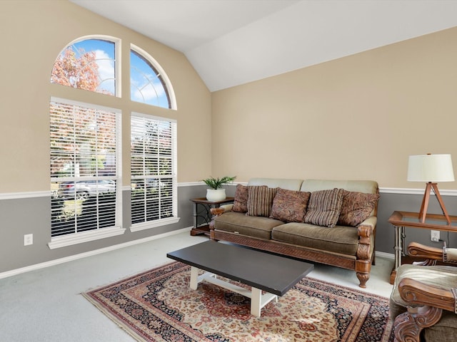 carpeted living room with lofted ceiling