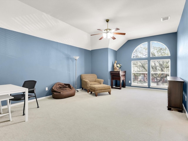 sitting room featuring light colored carpet, vaulted ceiling, and ceiling fan