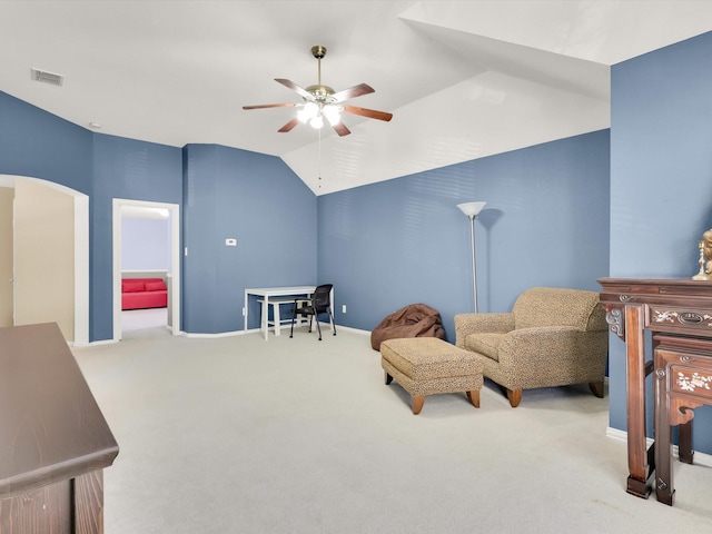 living area with light carpet, ceiling fan, and vaulted ceiling