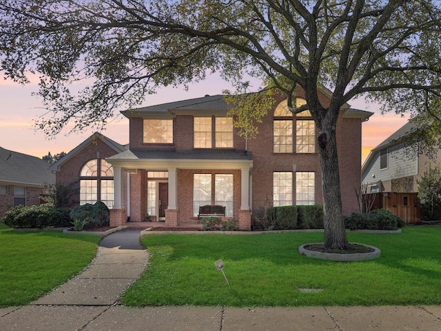 view of front of property featuring a yard and covered porch