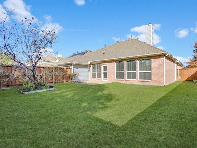 rear view of house with a lawn