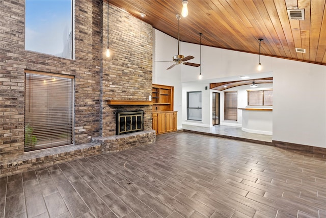 unfurnished living room featuring ceiling fan, high vaulted ceiling, wood ceiling, and a brick fireplace