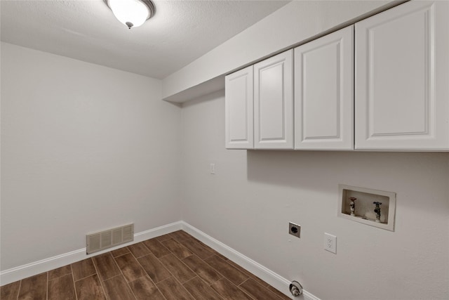 laundry room featuring electric dryer hookup, cabinets, and washer hookup