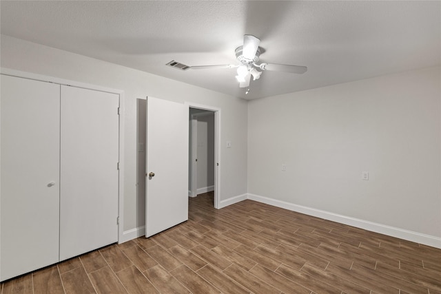 unfurnished bedroom with ceiling fan, a closet, and a textured ceiling