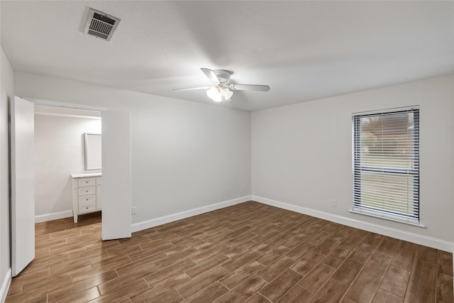 unfurnished bedroom featuring ceiling fan and a textured ceiling