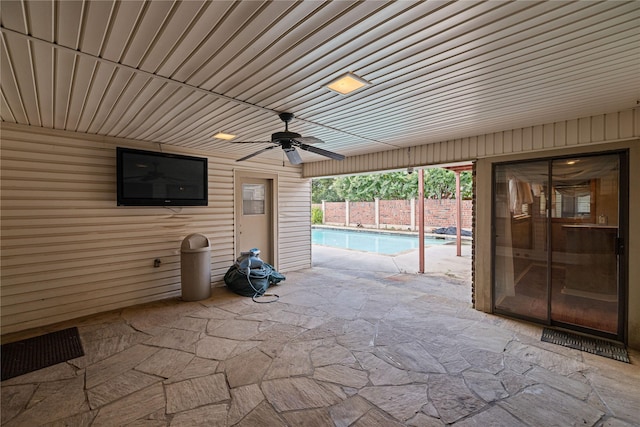 view of patio with a fenced in pool and ceiling fan