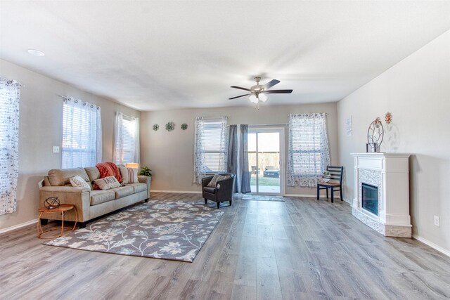 living room featuring ceiling fan and light wood-type flooring