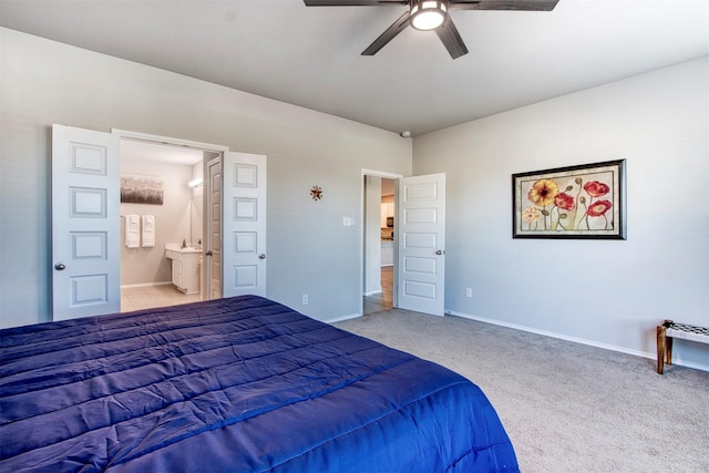 bedroom with ceiling fan, ensuite bathroom, and light carpet