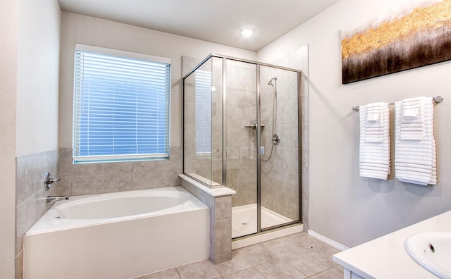 bathroom with plus walk in shower, tile patterned floors, and vanity