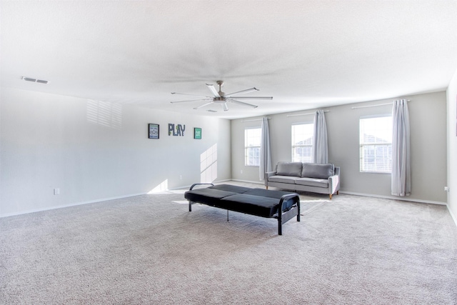 living room with light colored carpet, a textured ceiling, and ceiling fan