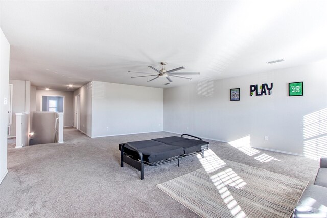 playroom with ceiling fan and light carpet