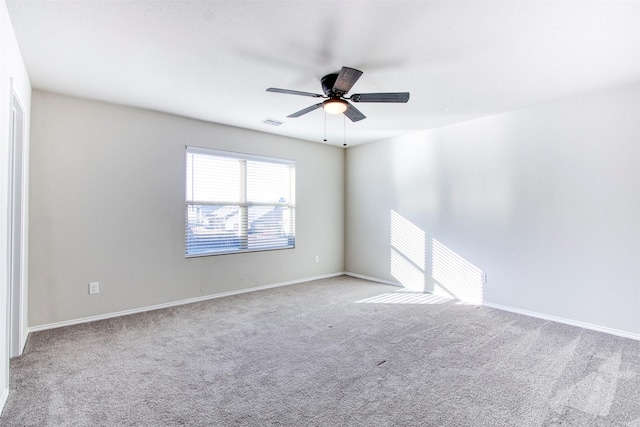 carpeted spare room with ceiling fan