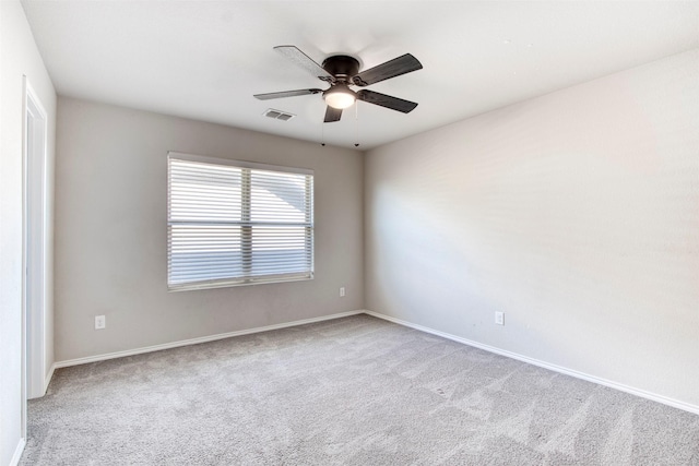 empty room featuring ceiling fan and light carpet