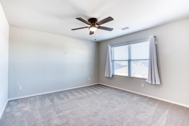 carpeted empty room featuring ceiling fan