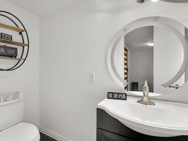 bathroom with toilet and vanity