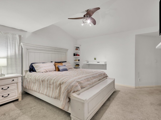 carpeted bedroom with vaulted ceiling and ceiling fan