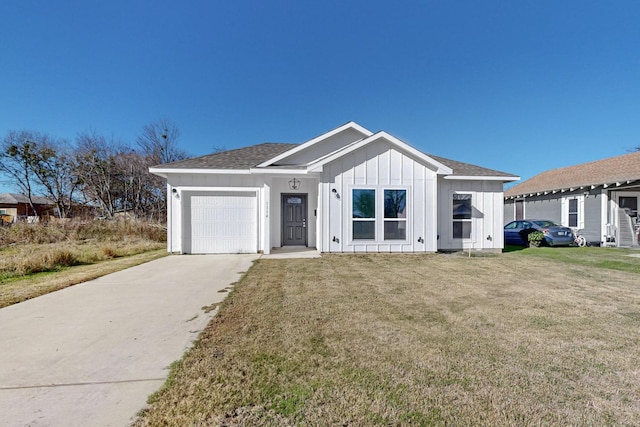 view of front of house with a garage and a front lawn