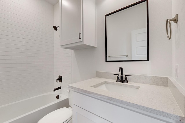 full bathroom featuring toilet, vanity, and tiled shower / bath