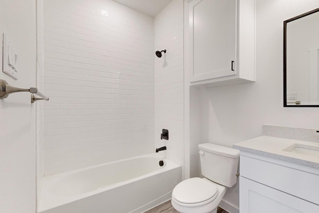 full bathroom featuring toilet, vanity, tiled shower / bath combo, and hardwood / wood-style flooring