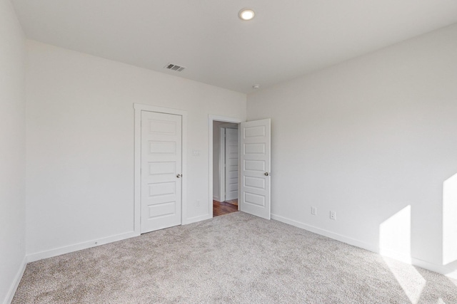 unfurnished bedroom featuring carpet floors and a closet